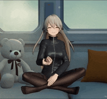 a girl sitting on a couch next to a teddy bear