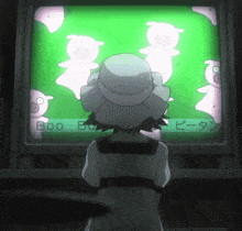 a girl in a white hat is looking at a screen that says boo boo