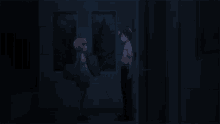 a man is holding a woman in his arms in a dark room
