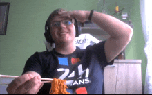 a man wearing headphones and a shirt that says 24h ans