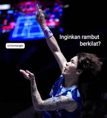 a man holding a badminton racket with the words " inginkan rambut berkilat " below him