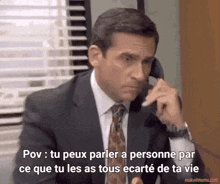 a man in a suit and tie is talking on a phone with the words pov tu peux parler a personne par