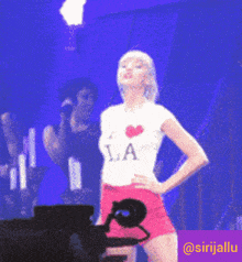 a woman wearing a shirt that says i love la on it