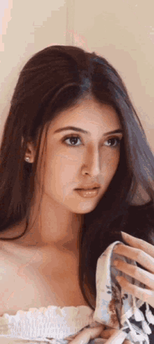 a close up of a woman 's face with a white top on