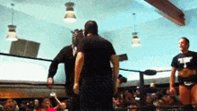 a man in a black shirt that says ' a ' on it