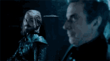 a man with a beard is sitting next to another man with a beard .