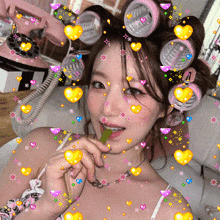 a woman with curlers in her hair is holding a green leaf