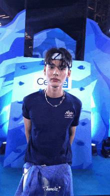 a young man wearing a blue shirt that says aloha