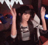 a woman sitting in a chair with her eyes closed and her hands in the air