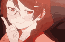 a close up of a girl wearing glasses and a red shirt making a funny face .
