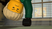 a lego character is doing a handstand in a room with a window in the background
