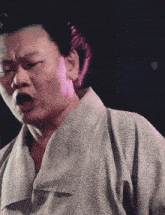 a man in a kimono is making a funny face with his mouth open