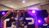 a man dancing in front of a sign that says cap toxicity