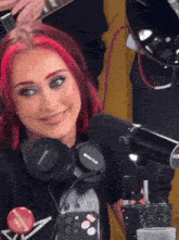 a woman with red hair wearing headphones and a button that says call me