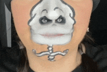 a woman has her face painted like a skeleton