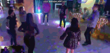 a group of people are dancing in a dark room with the words www.bandicam.com on the bottom right