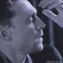 a close up of a man 's face with the words lokismarvel written below him