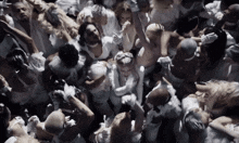 a crowd of people are gathered in a dark room