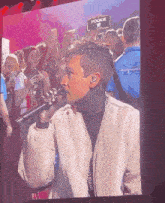 a man singing into a microphone with a sign that says pookie in the background