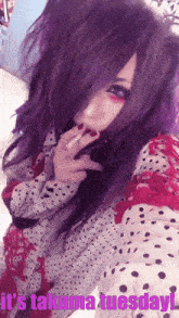 a woman with purple hair is taking a selfie with the words it 's takuma tuesday below her