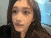 a close up of a woman 's face with her eyes closed