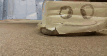 a piece of paper with a smiley face drawn on it is taped to the floor
