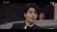 a man in a tuxedo with tvn written on the bottom