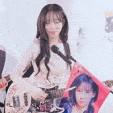a girl is holding a guitar with the number 1013 on it
