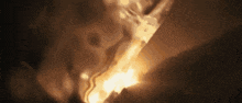 a close up of a person holding a torch in a dark room