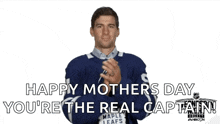 a man in a maple leafs jersey is applauding