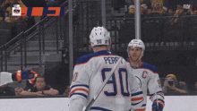 two hockey players one of whom has the number 50 on their jersey