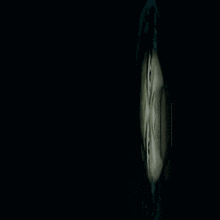 a close up of a person 's face in the dark