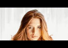 a close up of a woman 's face against a white background