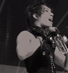 a black and white photo of a man singing