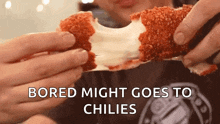 a person is holding a piece of food with the words bored might goes to chilies