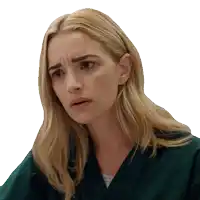 a woman with blonde hair is wearing a green scrub top and making a funny face