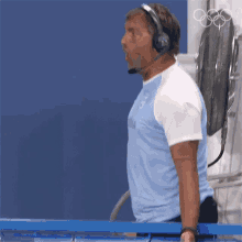 a man wearing headphones and a light blue shirt with argentina on it