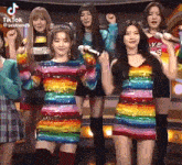 a group of girls are standing next to each other on a stage .