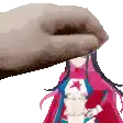 a pixel art of a hand touching a girl 's face .