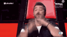 a man sitting in a chair with the words lavozkids1 on the top