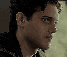 a close up of a man 's face with a serious look on his face and a serious look on his face .