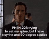 a man wearing headphones says phen 228 trying to eat his spine