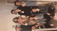 a group of young people are posing for a picture together in a room .