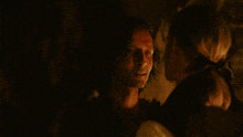 a man with a scar on his face is looking at another man