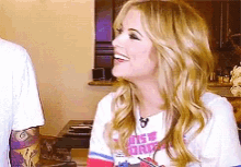 a woman wearing a t-shirt that says ' angels drive ' on it