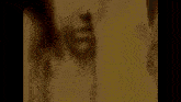 a close up of a woman 's face with a hand on her mouth .