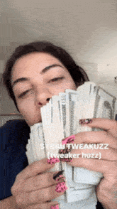 a woman is holding a bunch of money in her hands