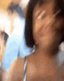 a blurry picture of a woman 's face with a blurred background