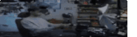 a blurry picture of a man sitting at a desk using a laptop computer .
