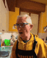 a man wearing glasses and an apron that says barbieri on it